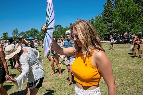 BROOK JONES/FREE PRESS
Folk Fest goer Ayla Prandzioch, 35, who is from Winnipeg, tries to keep cool with a hand fan while watching Yagódy perfrom on the Snowberry Field Stage on an extremely hot day at the 51st edition of the Winnipeg Folk Festival at Birds Hill Provincial Park in Manitoba on Sunday, July 12, 2026.