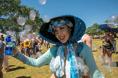 BROOK JONES/FREE PRESS
Folk Fest goer Lily Scott, who is from Edmonton, is pictured having fun with bubbles while watching Yagódy perform on the Snowberry Field Stage on an extremely hot day at the 51st edition of the Winnipeg Folk Festival at Birds Hill Provincial Park in Manitoba on Sunday, July 12, 2026.