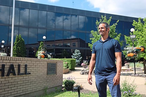 Enver Naidoo, the CEO of Westman Immigrant Services and a candidate for Ward 3 in the October election, stands outside city hall after announcing his election bid. (Alex Lambert/The Brandon Sun)