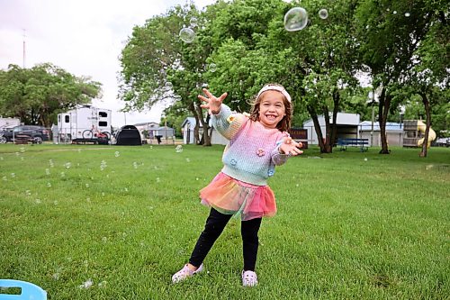 Three-year-old Emmy Brown plays with bubbles during the annual Hamiota Fair on Thursday. The fair included a variety of horse and cattle events, a parade, a pancake breakfast, a wide variety of games and other entertainment. See more photos on Page A3. (Tim Smith/The Brandon Sun)