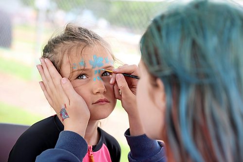Theo Knight of Hamiota has her face painted by Aubree Drul during the annual Hamiota Fair on Thursday. (Tim Smith/The Brandon Sun)