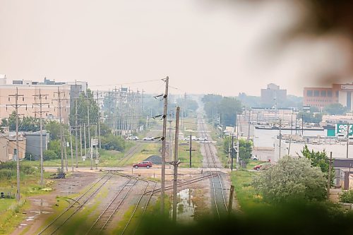 MIKE DEAL / FREE PRESS
The smokey view from the top of Garbage Hill in Westview Park looking south along the rail lines showing traffic crossing Sargent Avenue, Ellice Avenue and St. Matthews Avenue in Winnipeg. The smoke is caused by forest fires in Northwestern Ontario and poor air quality has been forecast, so, people with health risks should limit their time outdoors.
260717 - Friday, July 17, 2026.