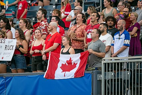 BROOK JONES/FREE PRESS
Ava Funk (left) and her dad Jason Funk, who are from Brandon, hold a Canadian flag during O Canada at Princess Auto Stadium on Saturday.