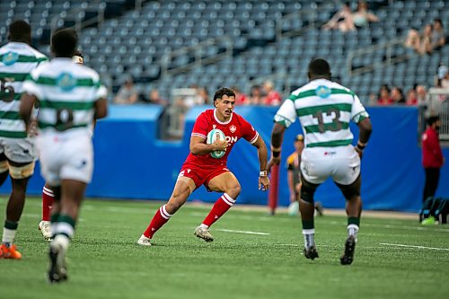 BROOK JONES/FREE PRESS
Canadian men’s national rugby union face No. 24 Zimbabwe In the third match of pool play in the inaugural World Rugby Nations Cup at Princess Auto Stadium in Winnipeg, Man., Saturday, July 18, 2026. Pictured: Team Canada player Noah Flesch (No. 11) runs with the ball while Team Zimbabwe Brandon Mudzekenyedzi (No. 13) covers him during first half action.