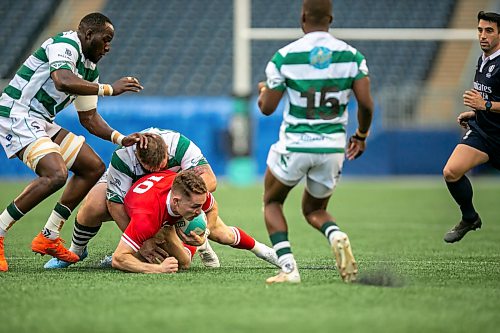 BROOK JONES/FREE PRESS
Canadian men’s national rugby union face No. 24 Zimbabwe In the third match of pool play in the inaugural World Rugby Nations Cup at Princess Auto Stadium in Winnipeg, Man., Saturday, July 18, 2026. Pictured: Team Canada palyer Cooper Coates (No. 10) runs with the ball while Zimbabwe player Tijde Vissern (No. 1) tackles him during first half action.