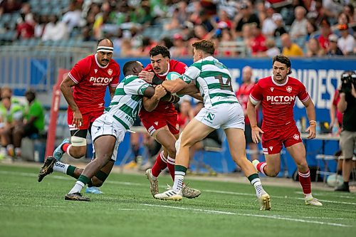 BROOK JONES/FREE PRESS
Canadian men’s national rugby union face No. 24 Zimbabwe In the third match of pool play in the inaugural World Rugby Nations Cup at Princess Auto Stadium in Winnipeg, Man., Saturday, July 18, 2026. Pictured: Team Canada player Noah Flesch (No. 11) runs with the ball while Team Zimbabwe Brandon Mudzekenyedzi (No. 13) and Zimbabwe teammate Matt McNab (No. 14) tackle him during first half action.