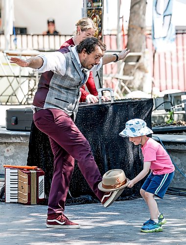 JOHN WOODS / FREE PRESS
Sammy Miller assists street performer Corey Pickett at the The Fringe Market Square stage Sunday, July 19, 2026.
reporter: standup