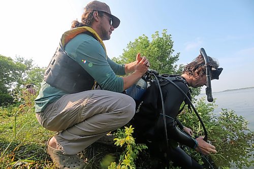 Austin Los of AAE Tech Services replaces an oxygen tank on a diver at Shoal Lake before going back out to calibrate bubblers. (Connor McDowell/The Brandon Sun)