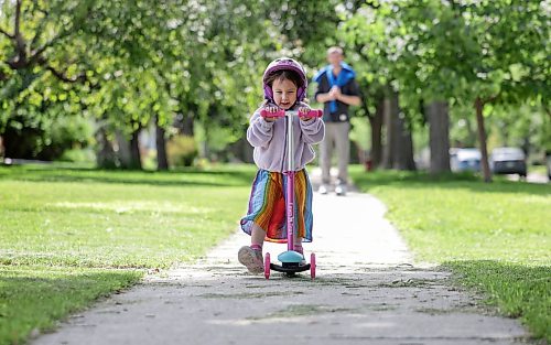Ruth Bonneville / Free Press

Standup -  Lil’ Scooter

Three-year-old Isla Drozdowski enjoys her afternoon hanging out with dad Jereme Drozdowski scooting along the sidewalk on Lockwood just prior to the duo heading out to the pool Tuesday. 

July 21st,  2026