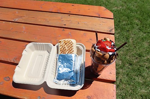 Happy Clover Food Truck's chicken shawarma wrap and bubble waffle with strawberry and assorted toppings are a winning combination at the fair. (Abiola Odutola/The Brandon Sun)