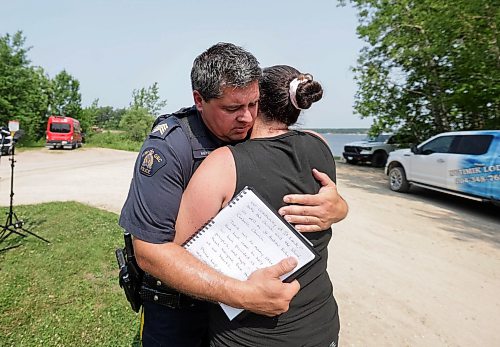 Ruth Bonneville / Free Press
Local RCMP update Nutimik search
RCMP Staff Sgt. Cory Myers gives Allison Baker-Thiessen, Nutimik Lodge owner a supportive hug just prior to her speaking with he media at a news presser at the boat launch at Nutimik Lake Thursday.
Story: RCMP confirmed at presser at the boat launch at Nutimik Lake that the body of the missing 10-year-old boy has been recovered following days of an intensive search near the falls at Nutimik Lake. Search and rescue teams including the RCMP, charitable organizations, local businesses and the members of the public continue to search for his 13-year-old brother.
Two boys, aged 10 and 13, slipped into the fast-moving rapids near Sturgeon Falls Trail in Manitoba's Nutimik Lake last Saturday, July 18th while with family,
See story by Moe
July 23rd, 2026
