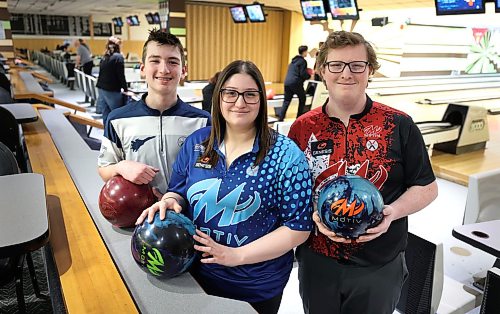 Israel Potter, right, is shown with his girlfriend Kristen Jolly and youth bowler Chase McVicar, left, at LaVérendrye Bowling Lanes in March. All three have earned spots on Canada's national bowling teams. (Ruth Bonneville/Winnipeg Free Press)