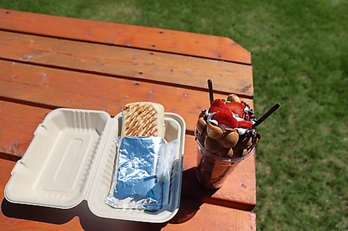 Happy Clover Food Truck's chicken shawarma wrap and bubble waffle with strawberry and assorted toppings are a winning combination at the fair. (Abiola Odutola/The Brandon Sun)