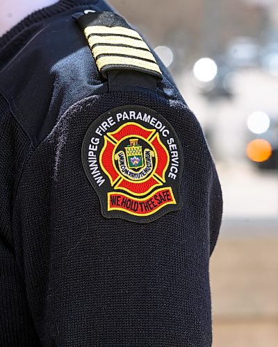 Mike Sudoma/Free Press
A WFPS badge on the sewn on the shoulder of WFPS Deputy Chief Scott Wilkinson during a media scrum Tuesday
May 12, 2026