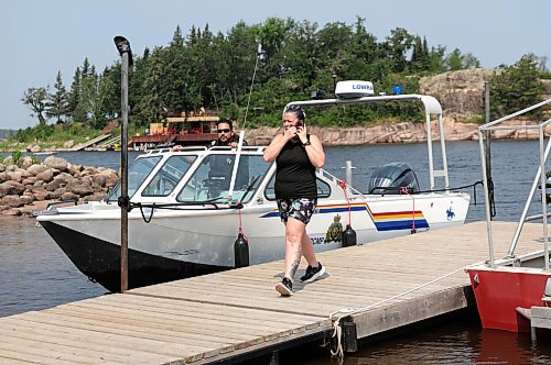 Ruth Bonneville / Free Press
Local RCMP update Nutimik search
Allison Baker-Thiessen, Nutimik Lodge owner, stands on the dock with the RCMP and others involved in the search and rescue efforts at Camp Nutimik Thursday. Allison Baker-Thiessen and her husband have been fully involved from the beginning in assisting with the rescue.
Story: RCMP confirmed at presser at the boat launch at Nutimik Lake that the body of the missing 10-year-old boy has been recovered following days of an intensive search near the falls at Nutimik Lake. Search and rescue teams including the RCMP, charitable organizations, local businesses and the members of the public continue to search for his 13-year-old brother. Two boys, aged 10 and 13, slipped into the fast-moving rapids near Sturgeon Falls Trail in Manitoba's Nutimik Lake last Saturday, July 18th while with family,
See story by Moe
July 23rd, 2026