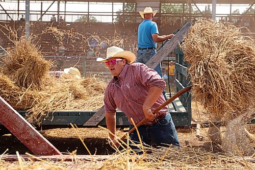 23072026
Caleb Nelson pitchforks sheaves of grain onto a horse-drawn cart during the threshing competition in the arena at the opening day of the 2026 Manitoba Thresherman’s Reunion and Stampede on Thursday afternoon.
(Tim Smith/The Brandon Sun)