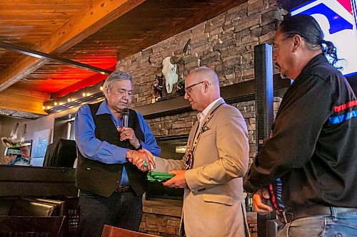 BROOK JONES/FREE PRESS
Members of the Indigenous Taxi Safety Committee and representatives from Duffy's Taxi and Unicity Taxi attend a breaking bread dinner with Winnipeg mayor Scott Gillingham at the Pony Corral on Nairn Avenue in Winnipeg, Man., Thursday, July 23, 2026. The event was held as a way to celebrate reconciliation and the taxi safety partnerships. Pictured: Eric Robinson (left) who is chairman of the taxi safety committee shakes the hand of Winnipeg Mayor Scott Gillingham (middle). Also pictured is Elder Carol Stone (right).