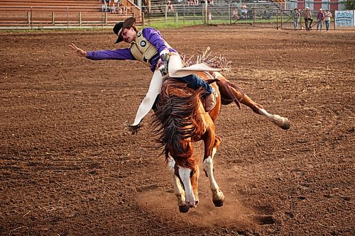 Corbin Boczkowski of Lethbridge, Alta., tries to stay atop his horse while competing in the novice bareback event at the opening go-round of the 2026 Manitoba Thresherman’s Reunion and Stampede rodeo on Thursday evening. (Tim Smith/The Brandon Sun)