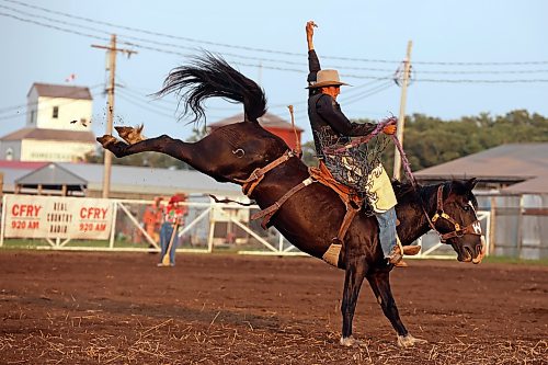 Trey Tuplin of Whitewood, Sask., holds on to stay in the saddle while competing in the saddle bronc event at the opening go-round of the 2026 Manitoba Thresherman’s Reunion and Stampede rodeo on Thursday evening. See more coverage on pages A4 and A5. (Tim Smith/The Brandon Sun)