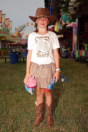 Seven-year-old Scotty Lewis of MacGregor with prizes she won playing midway games on Friday. The midway is a new addition to the Thresherman’s Reunion after a long absence from the four-day agricultural fair. (Tim Smith/The Brandon Sun)