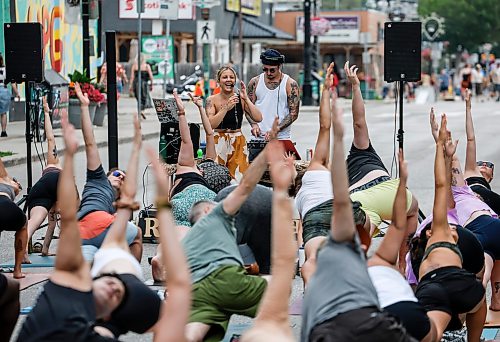 JOHN WOODS / FREE PRESS
Jessica from Rogue Vinyasa Yoga leads a session outside on a closed Corydon Avenue Sunday, July 26, 2026. The city is closing Corydon on multiple Sundays throughout the summer.

reporter: standup