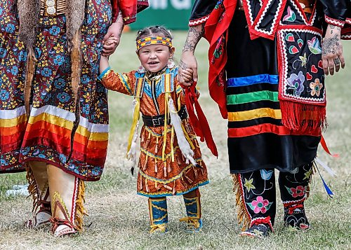 JOHN WOODS / FREE PRESS
Nahanni walks with her aunt Cayla Houle, left, and mother Destiny Houle walk hand-in-hand as they wait to participate in the grand entrance of the powwow at Anishinaabe Days Sunday, July 26, 2026.
reporter: standup