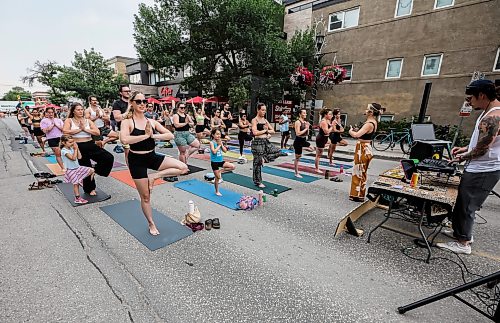 JOHN WOODS / FREE PRESS
Jessica from Rogue Vinyasa Yoga leads a session outside on a closed Corydon Avenue Sunday, July 26, 2026. The city is closing Corydon on multiple Sundays throughout the summer.
reporter: standup