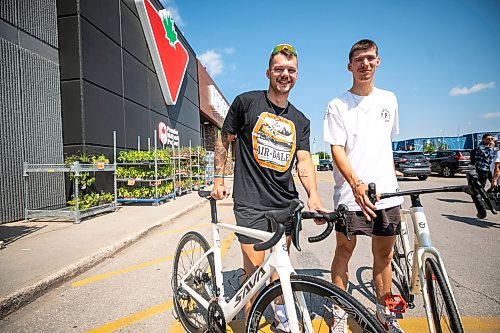 MIKAELA MACKENZIE / FREE PRESS
	
Val Duquenne (left) and Thomas Clark with their new bikes on Monday, July 27, 2026. The two are biking across Canada to raise awareness for menճ mental health, and have just gotten new bikes through community support after having their original ones stolen during their stop in Winnipeg.

For Tiago story.
Free Press 2026