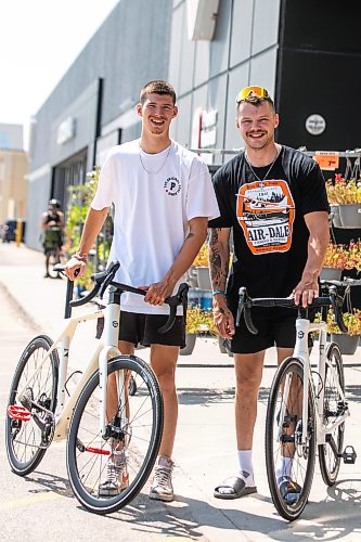 MIKAELA MACKENZIE / FREE PRESS
	
Thomas Clark (left) and Val Duquenne with their new bikes on Monday, July 27, 2026. The two are biking across Canada to raise awareness for menճ mental health, and have just gotten new bikes through community support after having their original ones stolen during their stop in Winnipeg.

For Tiago story.
Free Press 2026