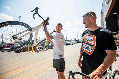 MIKAELA MACKENZIE / FREE PRESS
	
Thomas Clark (left) and Val Duquenne with their new bikes on Monday, July 27, 2026. The two are biking across Canada to raise awareness for menճ mental health, and have just gotten new bikes through community support after having their original ones stolen during their stop in Winnipeg.

For Tiago story.
Free Press 2026