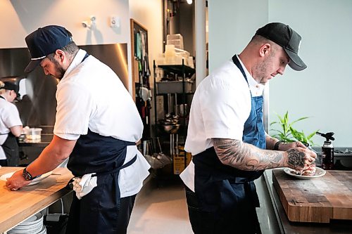 MIKAELA MACKENZIE / FREE PRESS
Brady Palmer (left) and Brent Genyk, the co-owners and head chefs of Sottobraccio, prepare dishes at the new Italian restaurant in Osborne Village on Wednesday, July 22, 2026.
For Eva story.
Free Press 2026