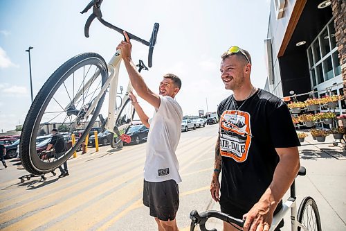 MIKAELA MACKENZIE / FREE PRESS
Thomas Clark (left) and Val Duquenne with their new bikes on Monday, July 27, 2026. The two are biking across Canada to raise awareness for menճ mental health, and have just gotten new bikes through community support after having their original ones stolen during their stop in Winnipeg.
For Tiago story.
Free Press 2026