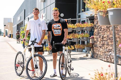 MIKAELA MACKENZIE / FREE PRESS
	
Thomas Clark (left) and Val Duquenne with their new bikes on Monday, July 27, 2026. The two are biking across Canada to raise awareness for menճ mental health, and have just gotten new bikes through community support after having their original ones stolen during their stop in Winnipeg.

For Tiago story.
Free Press 2026