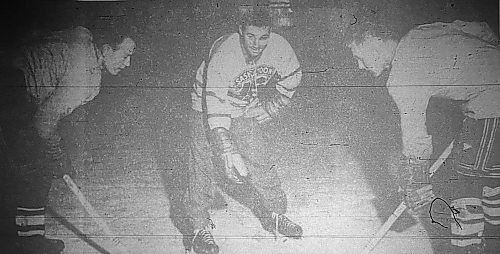 Len (Comet) Haley drops the puck between Bob Harper and Gord Cowan during a scrimmage at Brandon Regals training camp at Wheat City Arena on Sept. 25, 1956. Haley, who fractured his cheekbone and opened a cut under his eye on the opening day of camp, was able to help out but couldn't actually participate. (Brandon Sun files)