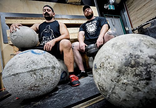 JOHN WOODS / FREE PRESS
Tyler Sigurdson, owner of Iron Age Strength and Conditioning gym, right, and Dan Cadger photographed with 350lb “stones” are training for the Strongman competition at the Gimli Icelandic Festival in the downtown Winnipeg gym in Tuesday, June 30, 2026.
reporter: eva