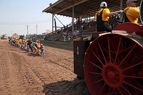 Volunteers test their collective strength in a tug-of-war against an antique steam powered tractor at the opening day of the 2026 Manitoba Thresherman’s Reunion and Stampede in July. (Tim Smith/The Brandon Sun)