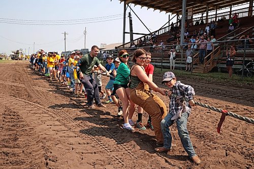 Volunteers test their collective strength in a tug-of-war against an antique steam powered tractor at the opening day of the 2026 Manitoba Thresherman’s Reunion and Stampede in July. (Tim Smith/The Brandon Sun)