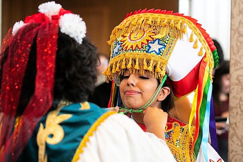 MIKAELA MACKENZIE / FREE PRESS
	
Alejandra Orellana (left) helps Cassandra Orellana with her outfit at City Hall as part of a flag-raising ceremony celebrating Peruvian indipendence day on Tuesday, July 28, 2026.

Standup.
Free Press 2026