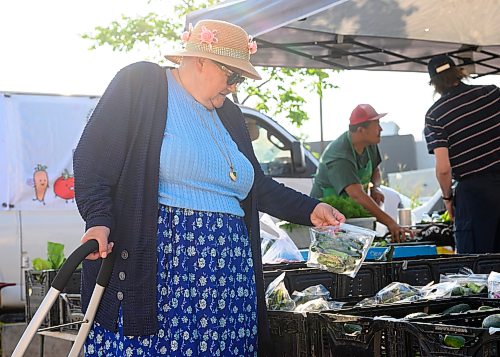 Mike Sudoma / Free Press
Kathy Janzen browses the produce at the ET Farms booth at the St Norbert Farmers Market Saturday morning
July 25, 2026