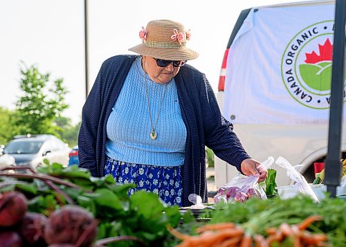 Mike Sudoma / Free Press
Kathy Janzen browses the produce at the ET Farms booth at the St Norbert Farmers Market Saturday morning
July 25, 2026