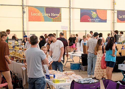 Mike Sudoma / Free Press
Shoppers are shoulder to shoulder visiting different vendors inside of the shelter at the St Norbert Farmers Market Saturday morning
July 25, 2026
