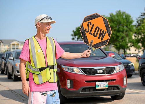 Mike Sudoma / Free Press
Crossing Guard Adam Affleck helps with the flow of both pedestrian and vehicular traffic control during the St Norbert Farmers Market peak business hours between 10:30am and 1:30pm Saturday afternoon
July 25, 2026