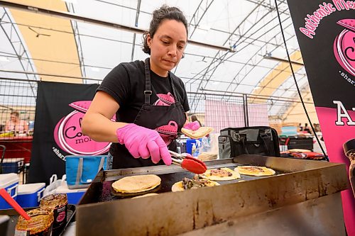 Mike Sudoma / Free Press
Los Comales Morales co-owner Helena Morales cooks up an order of quesadillas inside the St Norbert Farmers Market Saturday morning
July 25, 2026