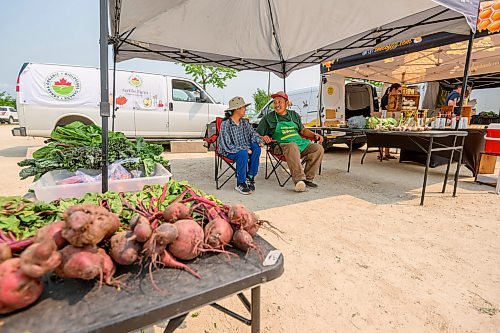 Mike Sudoma / Free Press
Ming Zhai and Tom Wang of Fertile Farms hangout under their booths canopy after a busy day and almost fully selling out of their inventory by 130pm
July 25, 2026