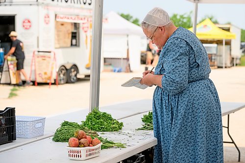 Mike Sudoma / Free Press
Mrs Reimer of Reimers Gardens does a final inventory count after being almost completely sold out of inventory after a steady stream of customers at the St Norbert Farmers Market Saturday afternoon
July 25, 2026