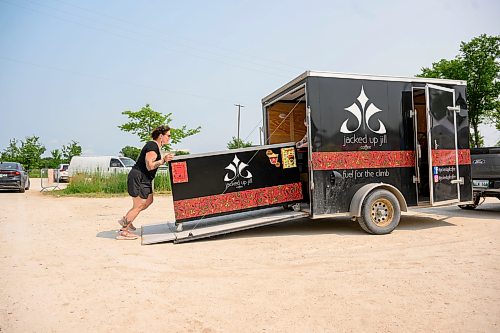 Mike Sudoma / Free Press
Louanne Vermetter of Jacked Up Jill Coffee pushes their booths cart into a trailer ask they pack up after a long hot Saturday at the St Norbert Farmers Market
July 25, 2026