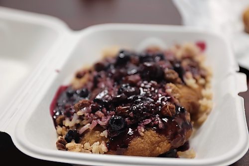 An Indigenous Delight, which is a piece of bannock, topped with rice, raisins and blueberry sauce and icing sugar, is pictured on Tuesday. The dish was served hot and people should have plenty of napkins ready. (Alex Lambert/The Brandon Sun)