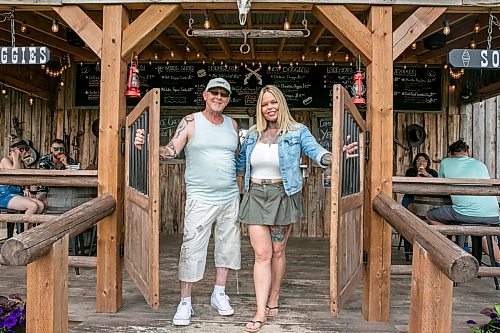BROOK JONES/FREE PRESS
 Star Giesbrecht and her husband Lee Giesbrecht opened the Starlette's Burger Saloon in May 2025 after Lee made the dining patio to like an old-fashioned, western saloon from recovered barn wood. Pictured: Lee (left) and Star hold open the saloon doors on Saturday, July 26, 2026. The Starlette's Burger Saloon at 60122 Juno Rd., just north of Elma, Man.