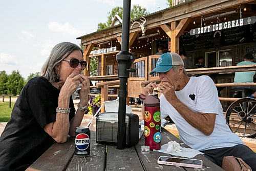 BROOK JONES/FREE PRESS
Star Giesbrecht and her husband Lee Giesbrecht opened the Starlette's Burger Saloon at 60122 Juno Rd., just north of Elma, Man., in May 2025 after Lee made the dining patio to look like an old-fashioned western saloon from recovered barn wood. Shelly (left) and Gary Arnold, who are from Winnipeg, Man., are pictured eating burgers on Saturday, July 25, 2026. It was the couple's third time visiting Starlette's Burger Saloon so far this year.