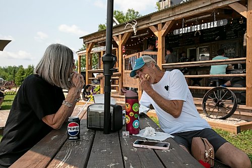 BROOK JONES/FREE PRESS
Star Giesbrecht and her husband Lee Giesbrecht opened the Starlette's Burger Saloon at 60122 Juno Rd., just north of Elma, Man., in May 2025 after Lee made the dining patio to look like an old-fashioned western saloon from recovered barn wood. Shelly (left) and Gary Arnold, who are from Winnipeg, Man., are pictured eating burgers on Saturday, July 25, 2026. It was the couple's third time visiting Starlette's Burger Saloon so far this year.